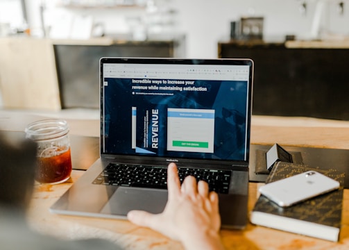 Person reviewing a revenue-focused webpage on a laptop